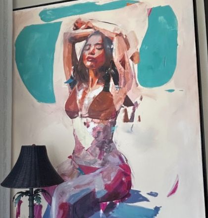 A large abstract painting of a woman in layered pinks and purples, posing with arms raised, set against teal shapes; a black lamp sits foreground.