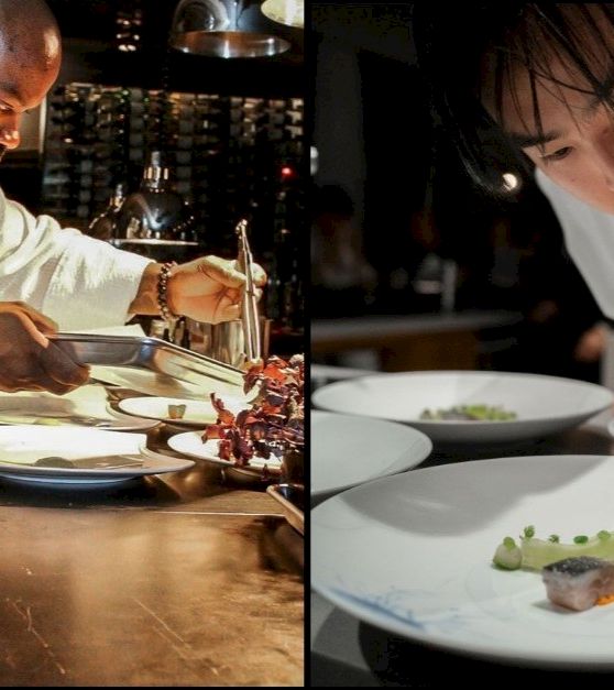 The image shows two chefs plating food at a restaurant, carefully garnishing dishes on white plates.