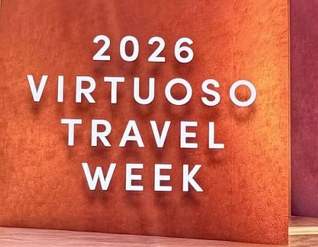 A sign reads “2026 Virtuoso Travel Week”.